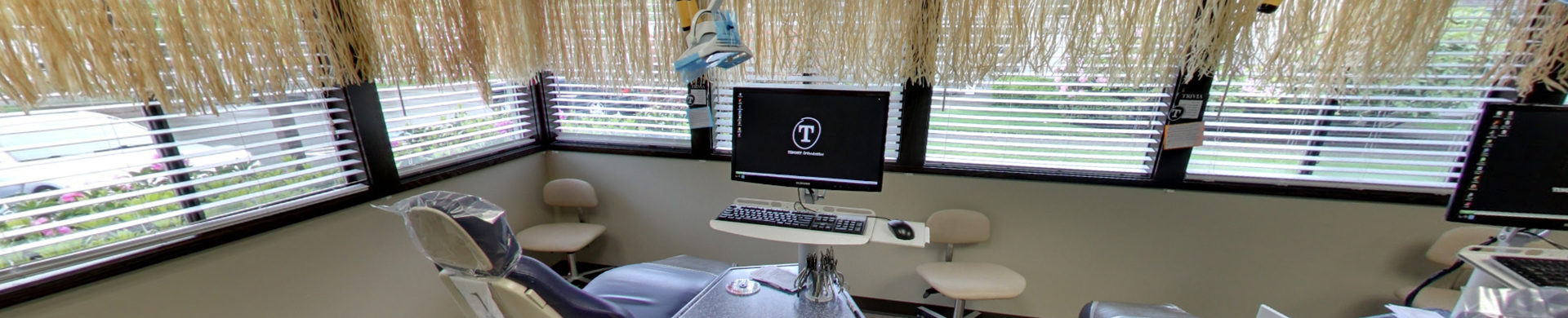 Patient receiving orthodontic treatment in modern dental office treatment room with equipment.